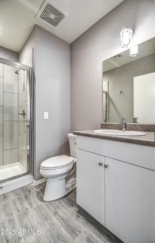 a bathroom with a toilet sink and shower