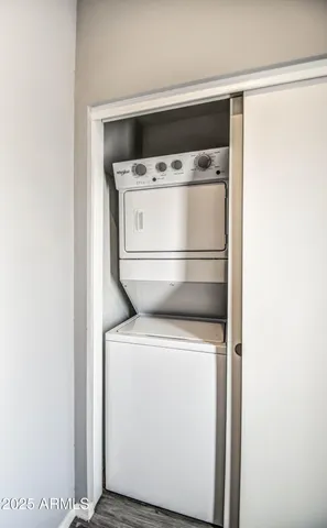 a close view of washer and dryer with wooden floor