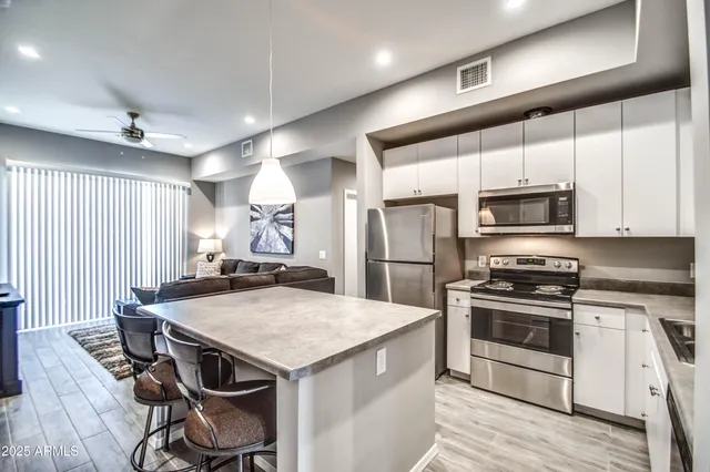 a kitchen with a stove a sink and a refrigerator