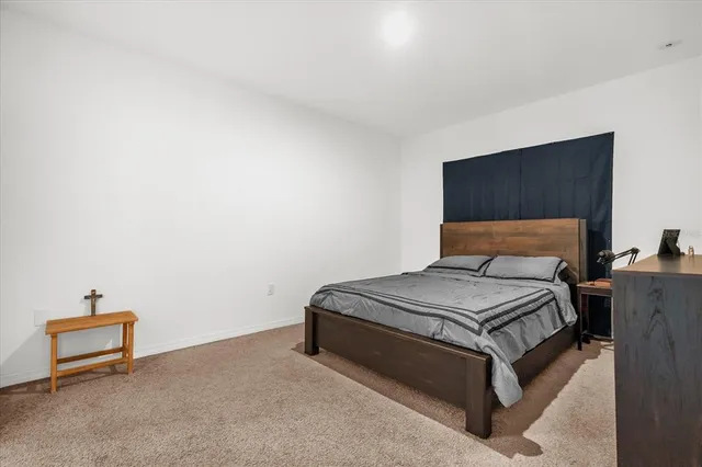 a bedroom with a bed and a dresser