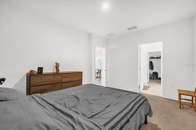 a bedroom with a bed and a mirror