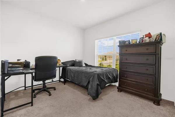 a bedroom with a bed and a chair