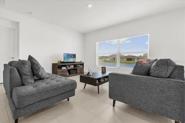 a living room with furniture and a large window