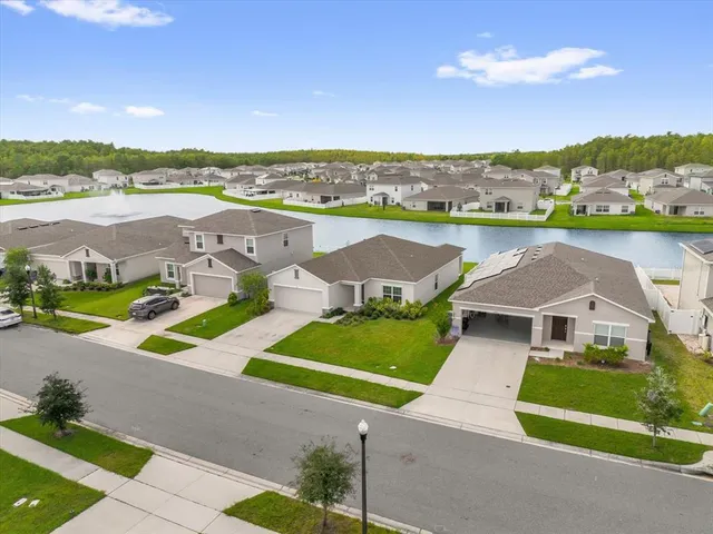 an aerial view of residential houses with outdoor space and city view