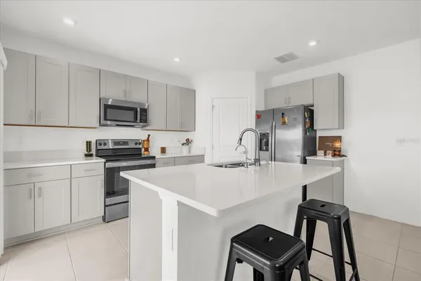 a kitchen with a sink cabinets and stainless steel appliances