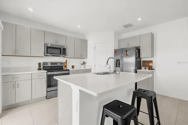 a kitchen with a sink cabinets and stainless steel appliances