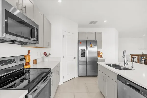 a kitchen with granite countertop a sink and stainless steel appliances