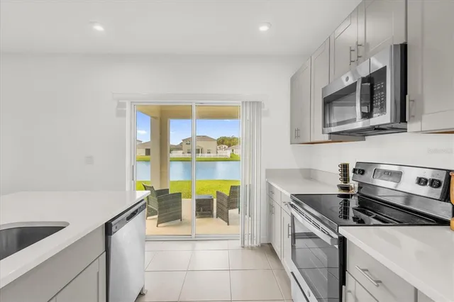 a kitchen with stainless steel appliances a sink a stove and cabinets