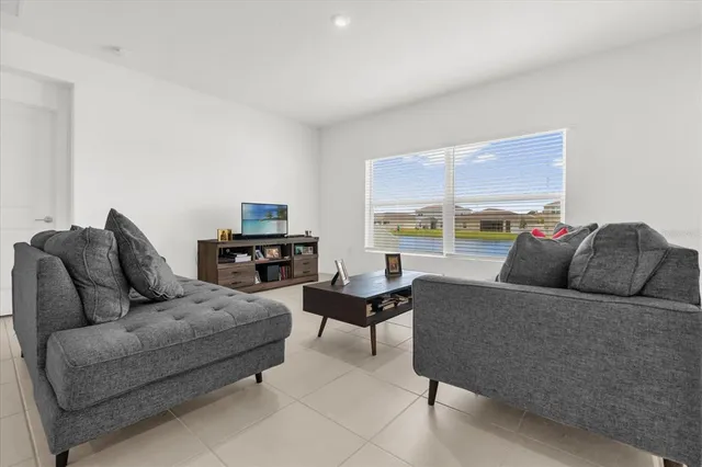 a living room with furniture and a large window