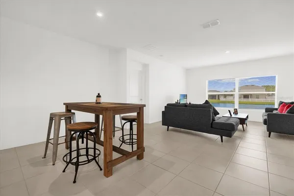 a bedroom with a bed and a lamp on desk