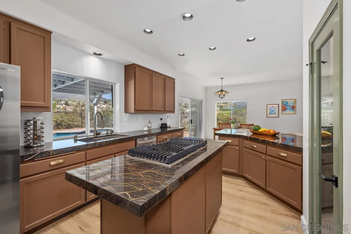 2259 Rolling Ridge Road Chula Vista, CA 91914 - Photo 15 of 52 a kitchen with stainless steel appliances granite countertop a sink stove and refrigerator