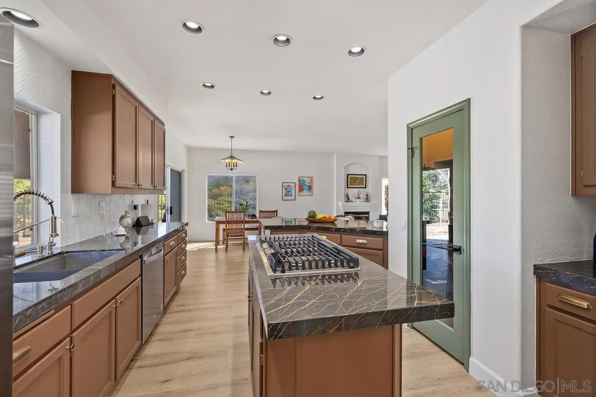 2259 Rolling Ridge Road Chula Vista, CA 91914 - Photo 16 of 52 a kitchen with granite countertop a sink and cabinets