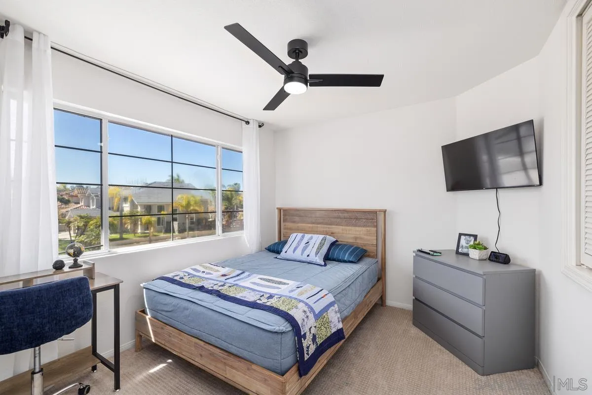 2259 Rolling Ridge Road Chula Vista, CA 91914 - Photo 38 of 52 a bedroom with a large bed and a flat screen tv