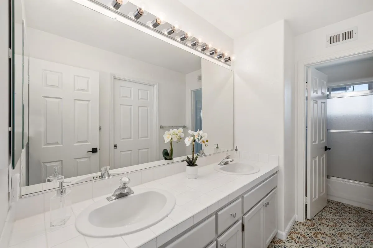 2259 Rolling Ridge Road Chula Vista, CA 91914 - Photo 43 of 52 a bathroom with a sink and a mirror