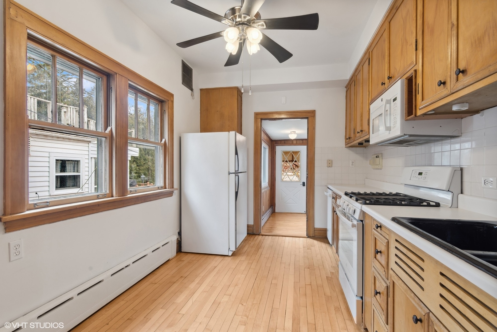 222 North Merrill Street Park Ridge, IL 60068 - Photo 8 of 20 a kitchen with stainless steel appliances granite countertop a refrigerator a sink dishwasher a stove and white countertops with wooden floor
