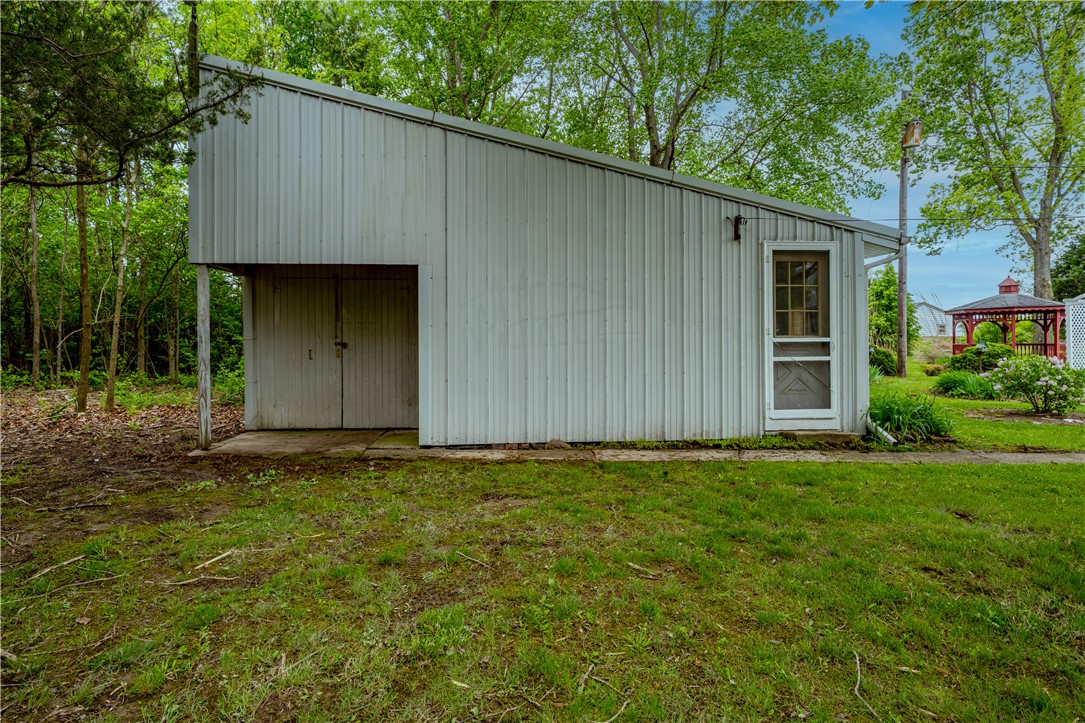 11296 Pansing Road Brookville, OH 45309 - Photo 41 of 53 This versatile outbuilding offers ample storage and a practical entry, blending utility with natural surroundings.