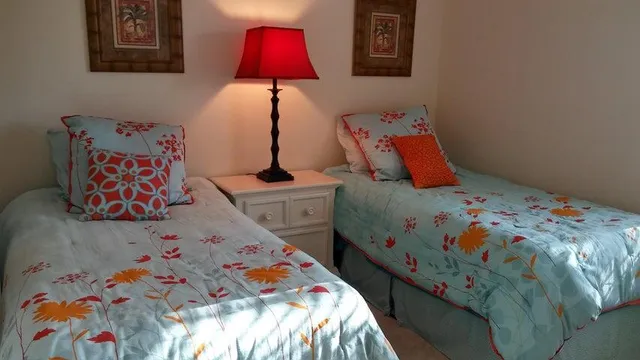 a bedroom with bed and painting on the wall