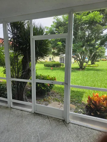 a view of backyard with large trees and plants