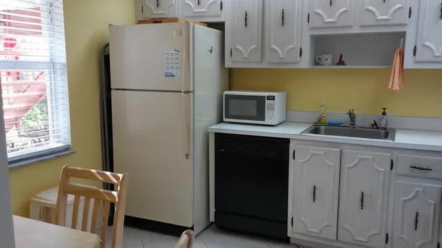 a kitchen with a refrigerator and a sink