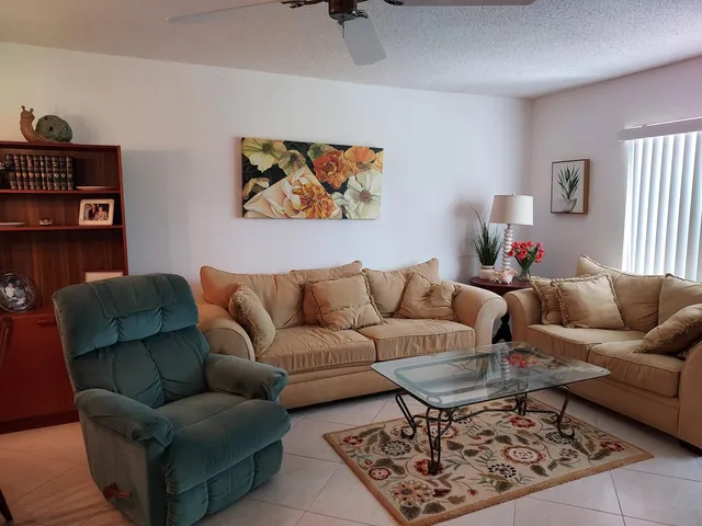 a living room with furniture a rug and a window