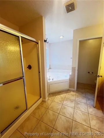 a bath tub sitting in a bathroom next to a window