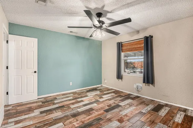 a view of a livingroom with a window and a ceiling fan