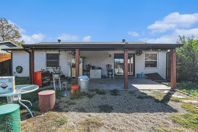 a view of a chairs and table in patio