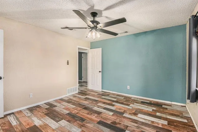 a view of a room with a ceiling fan