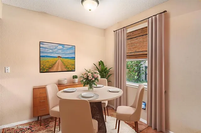 a view of a dining room with furniture and window