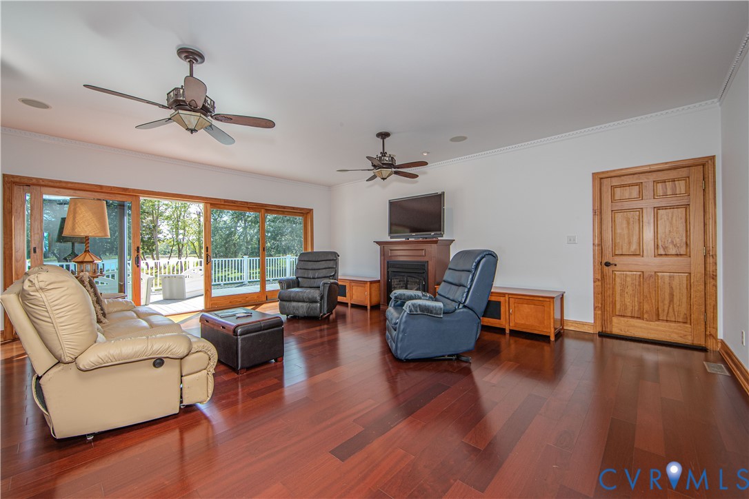19220 Mink Farm Road Onancock, VA 23417 - Photo 15 of 50 a living room with furniture and a flat screen tv with wooden floor