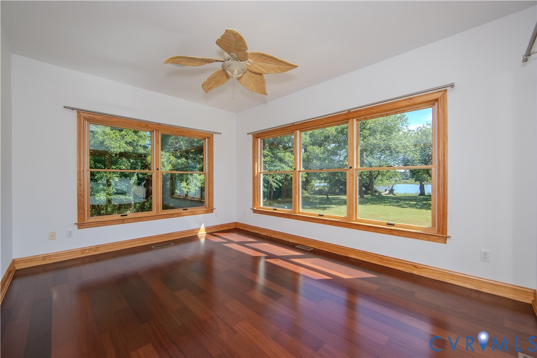 19220 Mink Farm Road Onancock, VA 23417 - Photo 20 of 50 a view of an empty room with wooden floor and a window