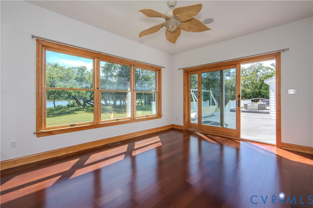 19220 Mink Farm Road Onancock, VA 23417 - Photo 21 of 50 a view of an empty room with wooden floor and a window