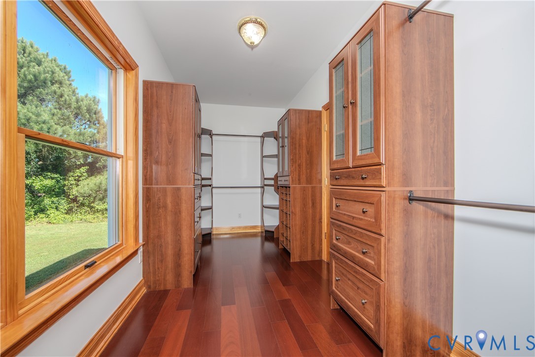 19220 Mink Farm Road Onancock, VA 23417 - Photo 27 of 50 a view of walk in closet with wooden floor and a large window