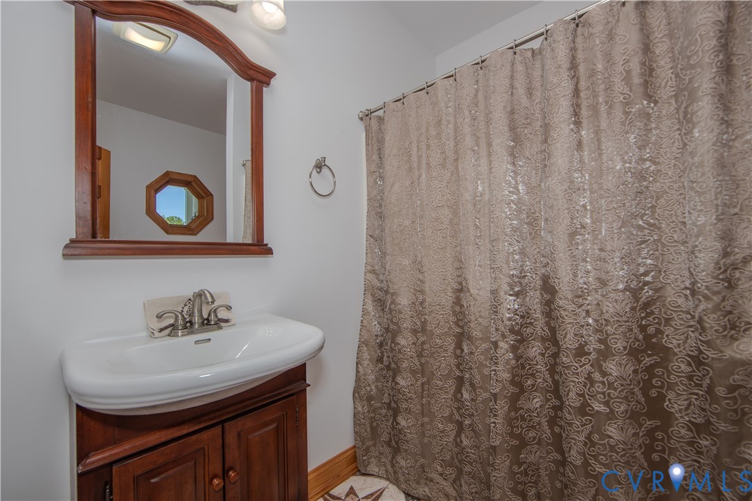 19220 Mink Farm Road Onancock, VA 23417 - Photo 33 of 50 a bathroom with a sink and a mirror