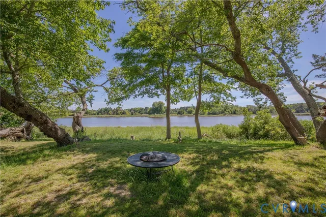 a view of lake with green yard