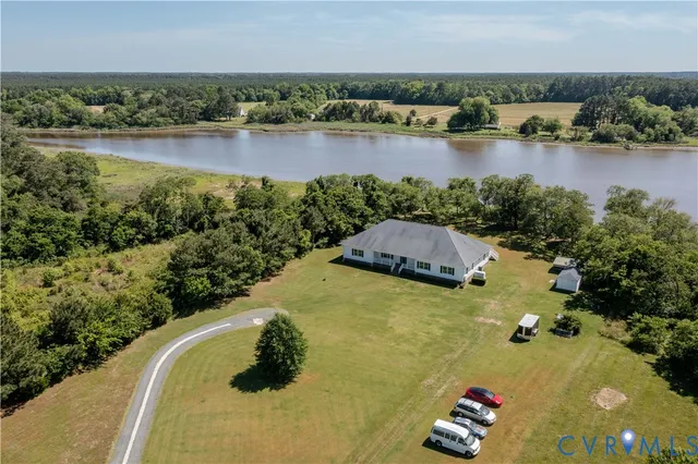 an aerial view of a houses with a lake view