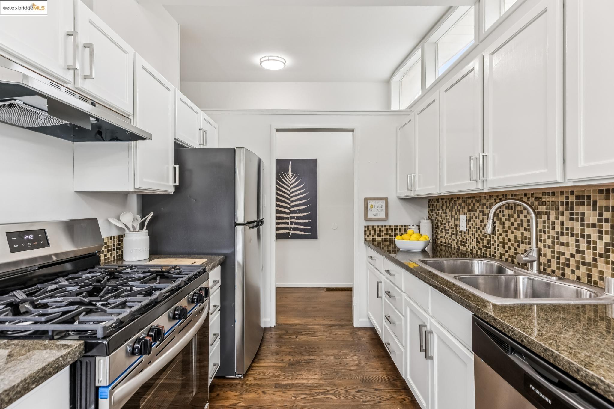 5619 Doremus Avenue Richmond, CA 94805 - Photo 8 of 45 a kitchen with granite countertop a sink a stove and cabinets