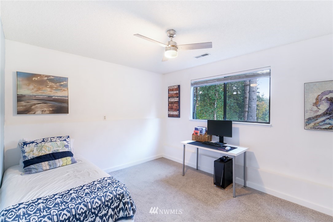 2507 Rocky Point Road Northwest Bremerton, WA 98312 - Photo 13 of 31 a bedroom with furniture and a window