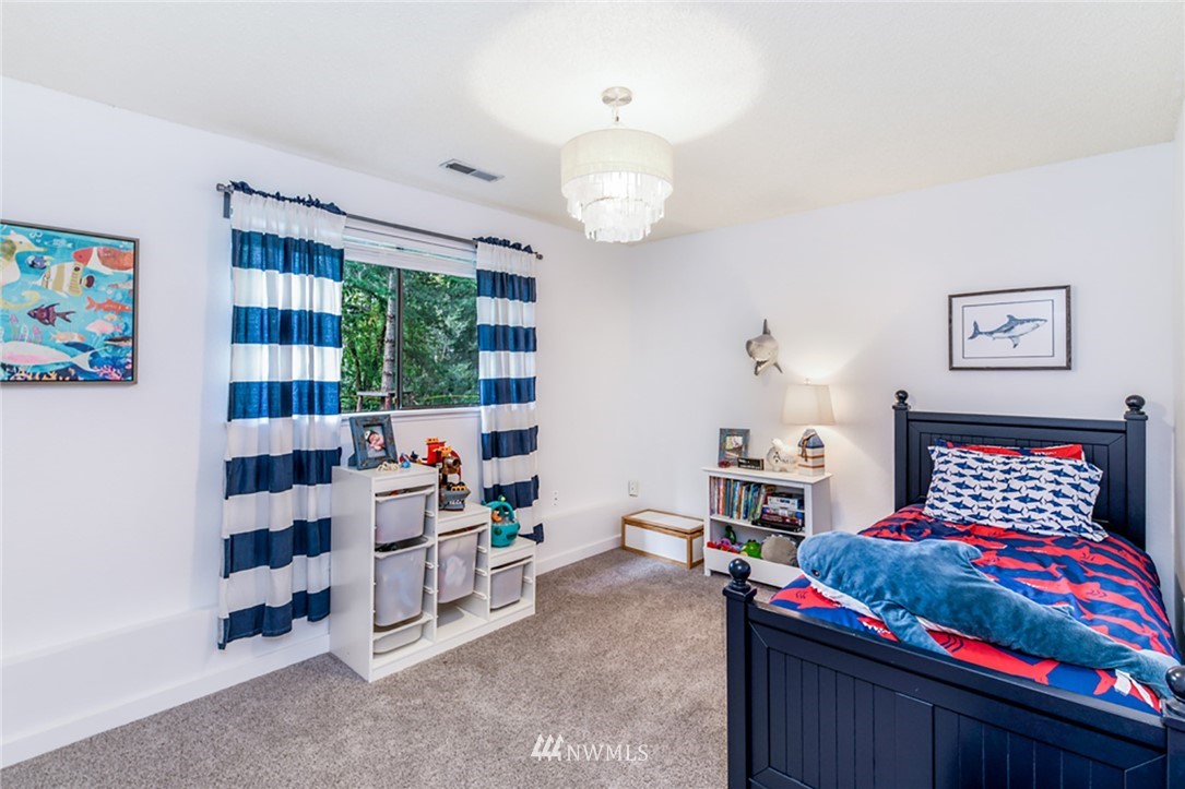 2507 Rocky Point Road Northwest Bremerton, WA 98312 - Photo 14 of 31 a living room with lots of furniture and a chandelier