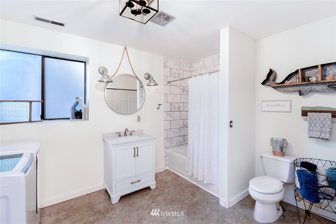 2507 Rocky Point Road Northwest Bremerton, WA 98312 - Photo 15 of 31 a bathroom with a sink toilet and mirror