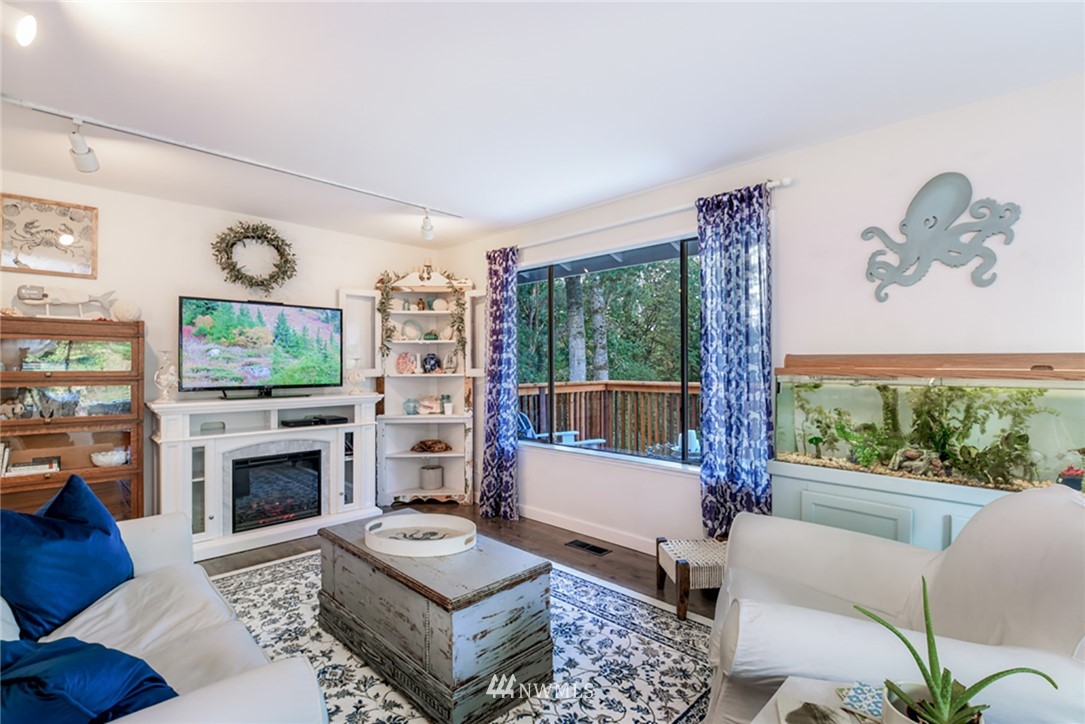 2507 Rocky Point Road Northwest Bremerton, WA 98312 - Photo 4 of 31 a living room with furniture a flat screen tv and a fireplace