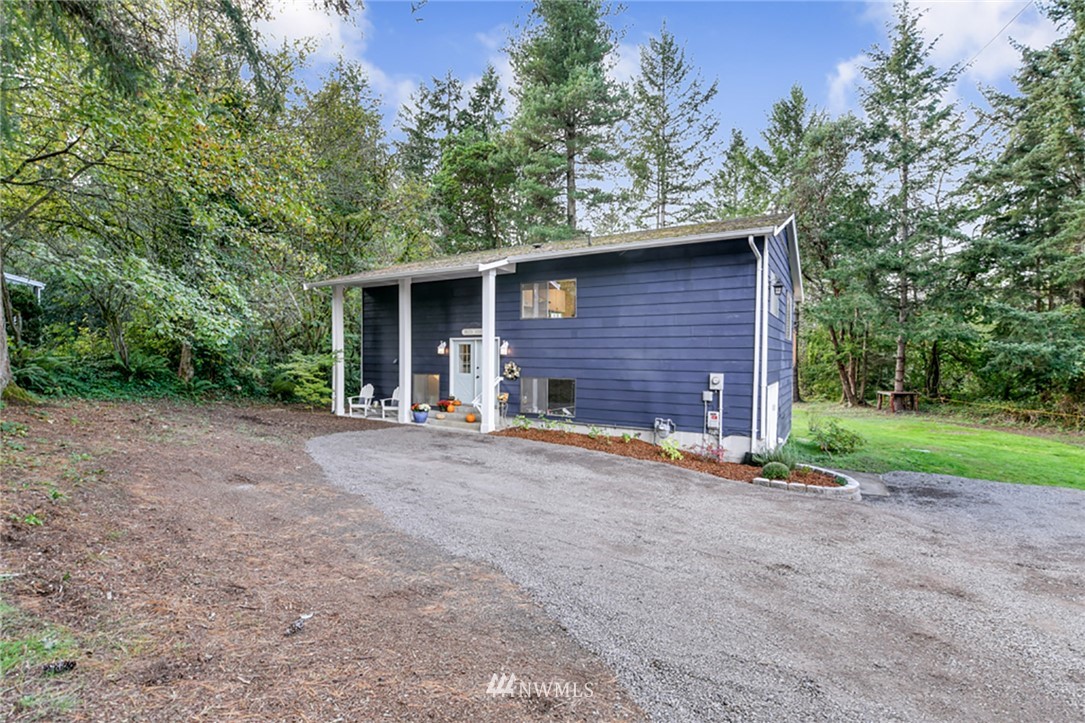 2507 Rocky Point Road Northwest Bremerton, WA 98312 - Photo 31 of 31 a view of a house with backyard and trees