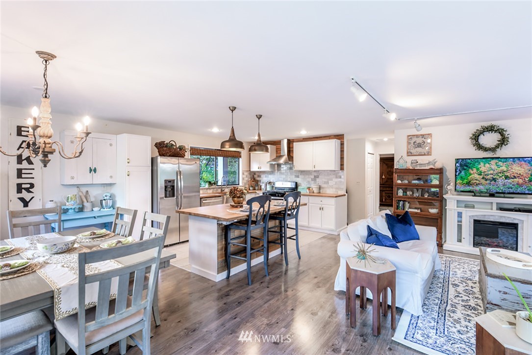 2507 Rocky Point Road Northwest Bremerton, WA 98312 - Photo 6 of 31 a large kitchen with a table and chairs