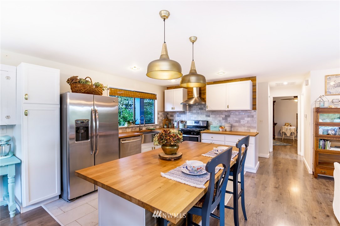 2507 Rocky Point Road Northwest Bremerton, WA 98312 - Photo 7 of 31 a kitchen with stainless steel appliances granite countertop a dining table and chairs