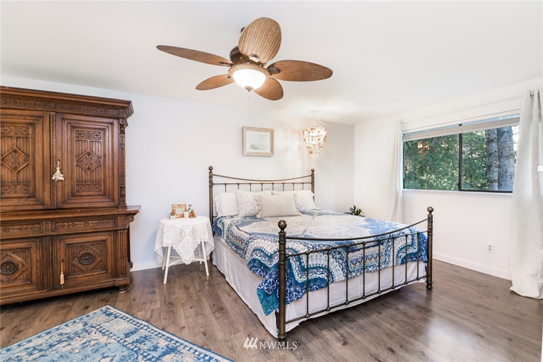 2507 Rocky Point Road Northwest Bremerton, WA 98312 - Photo 10 of 31 a bedroom with a bed and wooden floor