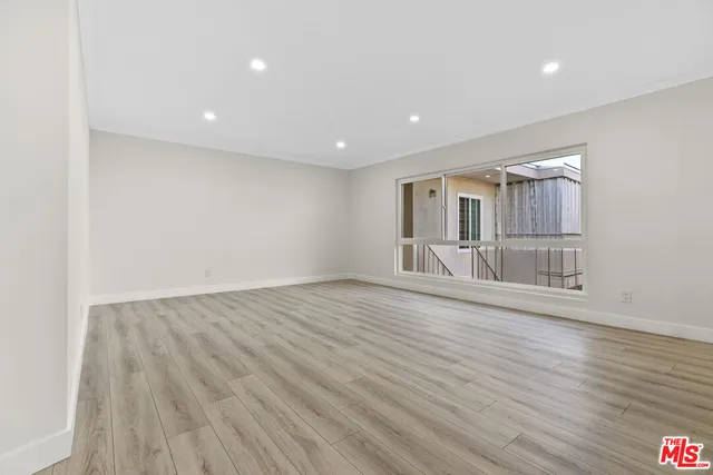 a view of a room with wooden floor