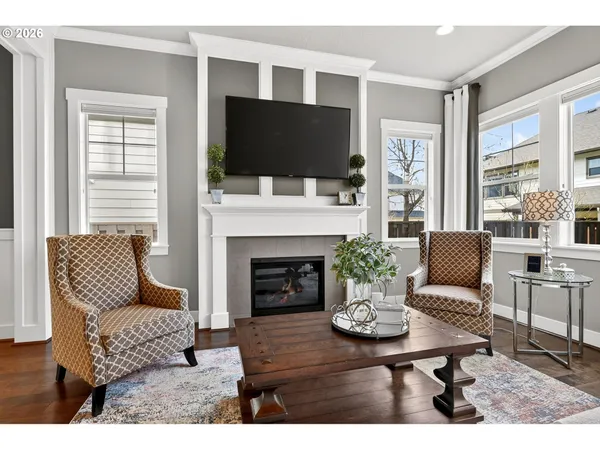 a living room with furniture a flat screen tv and a fireplace