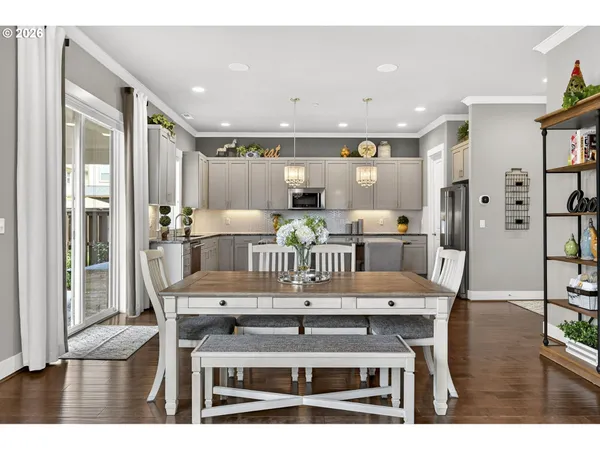 a dining room with furniture and wooden floor