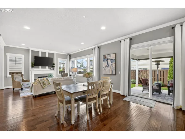 a dining room with furniture and wooden floor