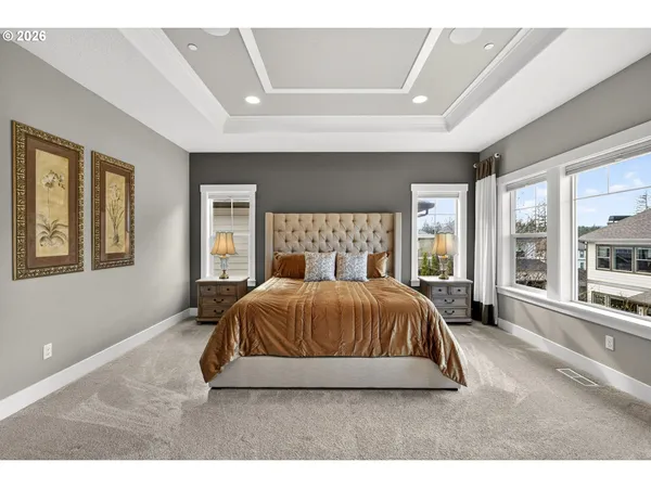 a bedroom with a large bed and a large window